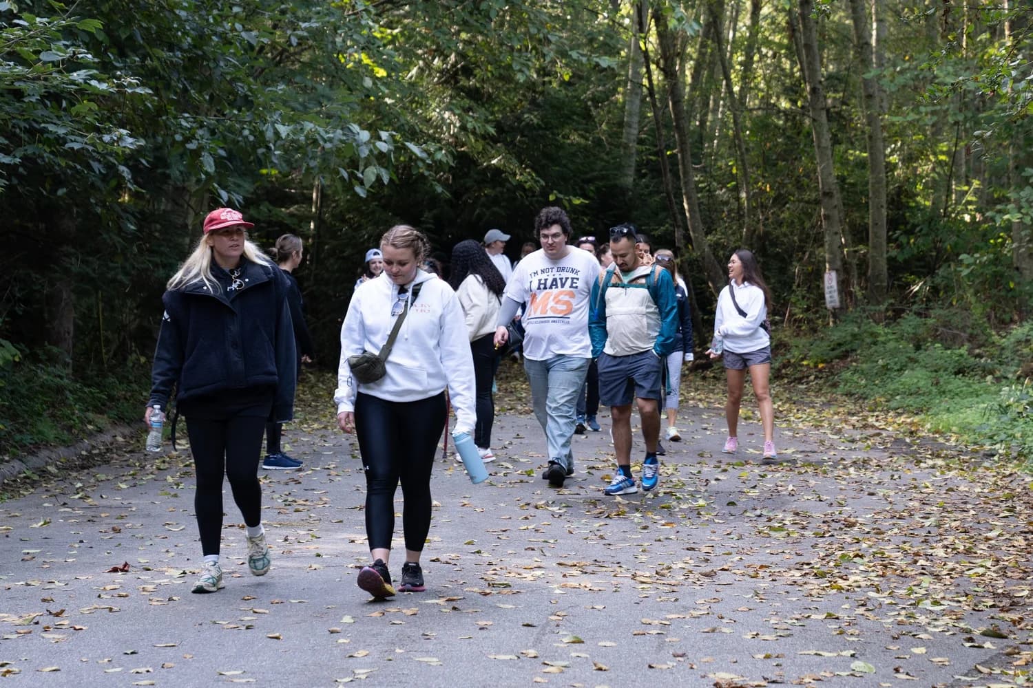 Members of the MS, I’mpossible community walking together outdoors